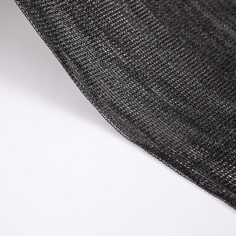 Black tape HDPE shade net mesh seen at an angle showing the knitted structure