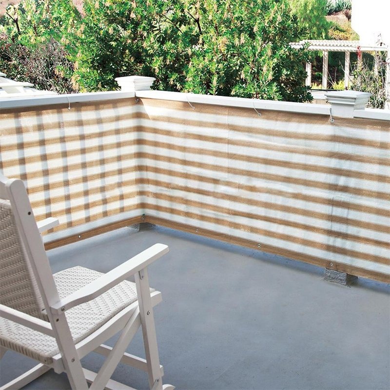 Beige and white striped HDPE sun shade net fitted to a terrace