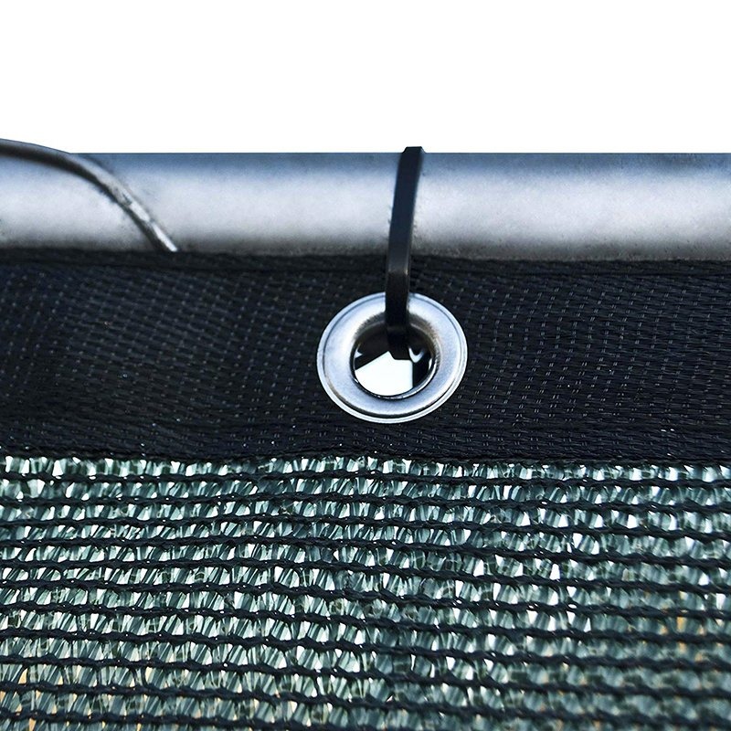 Green privacy screen mesh with a chrome grommet and tie in close view