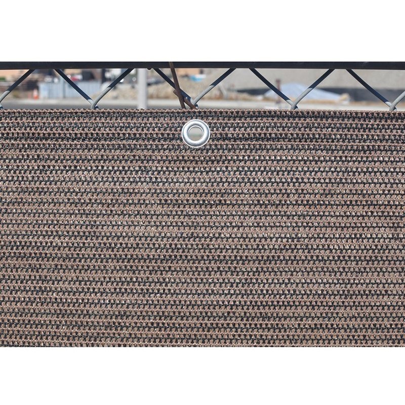 Green privacy screen mesh on a chain link fence with a chrome grommet in view
