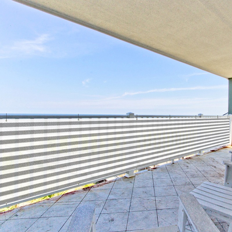 Grey striped HDPE balcony shade net fitted to a terrace with a sea view