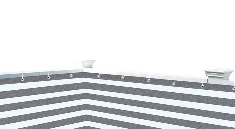 Grey striped HDPE shade net fitted along a fence with metal grommets