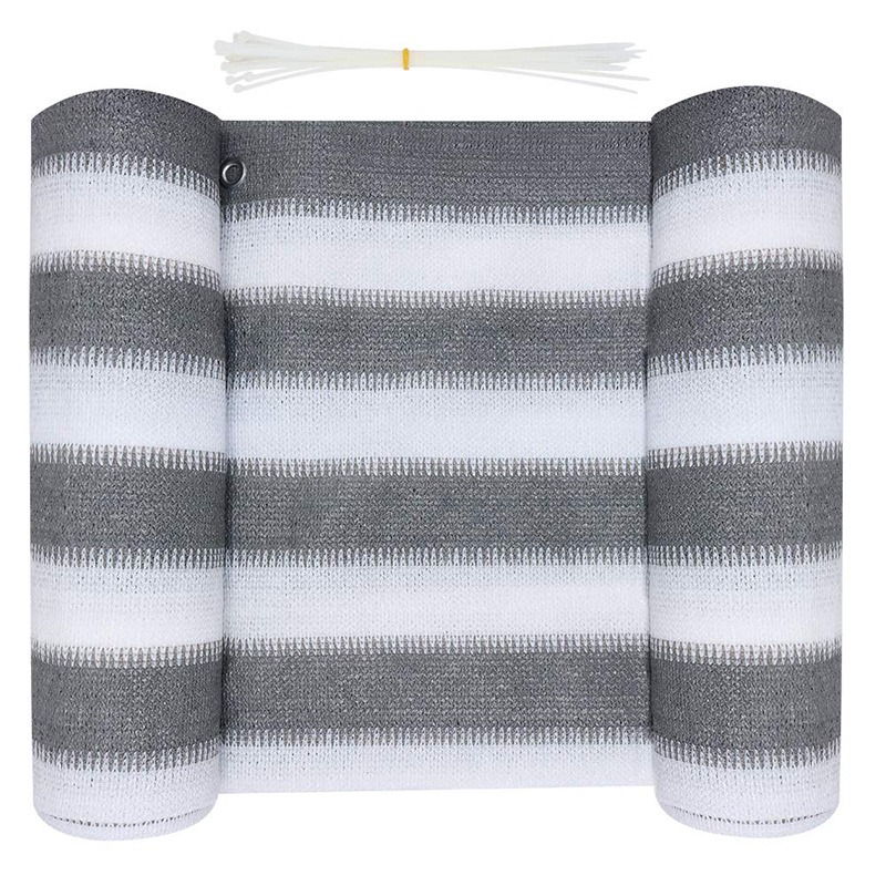 Rolled grey and white striped HDPE shade net with zip ties