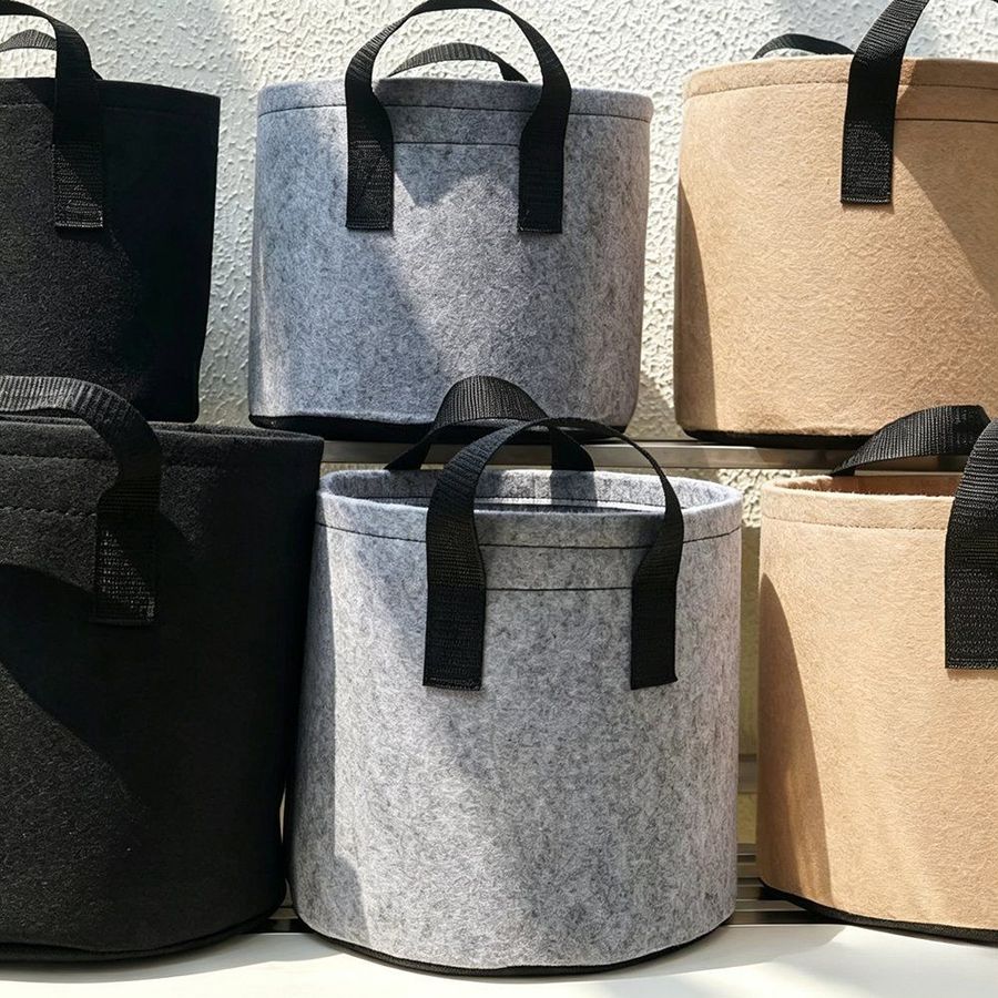 Five grow bags in different colours arranged together against a plain background