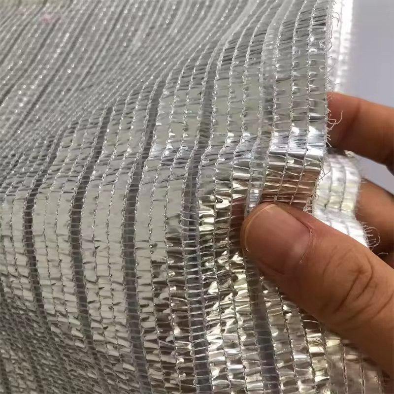 Reflective aluminised shade net surface held up to the light