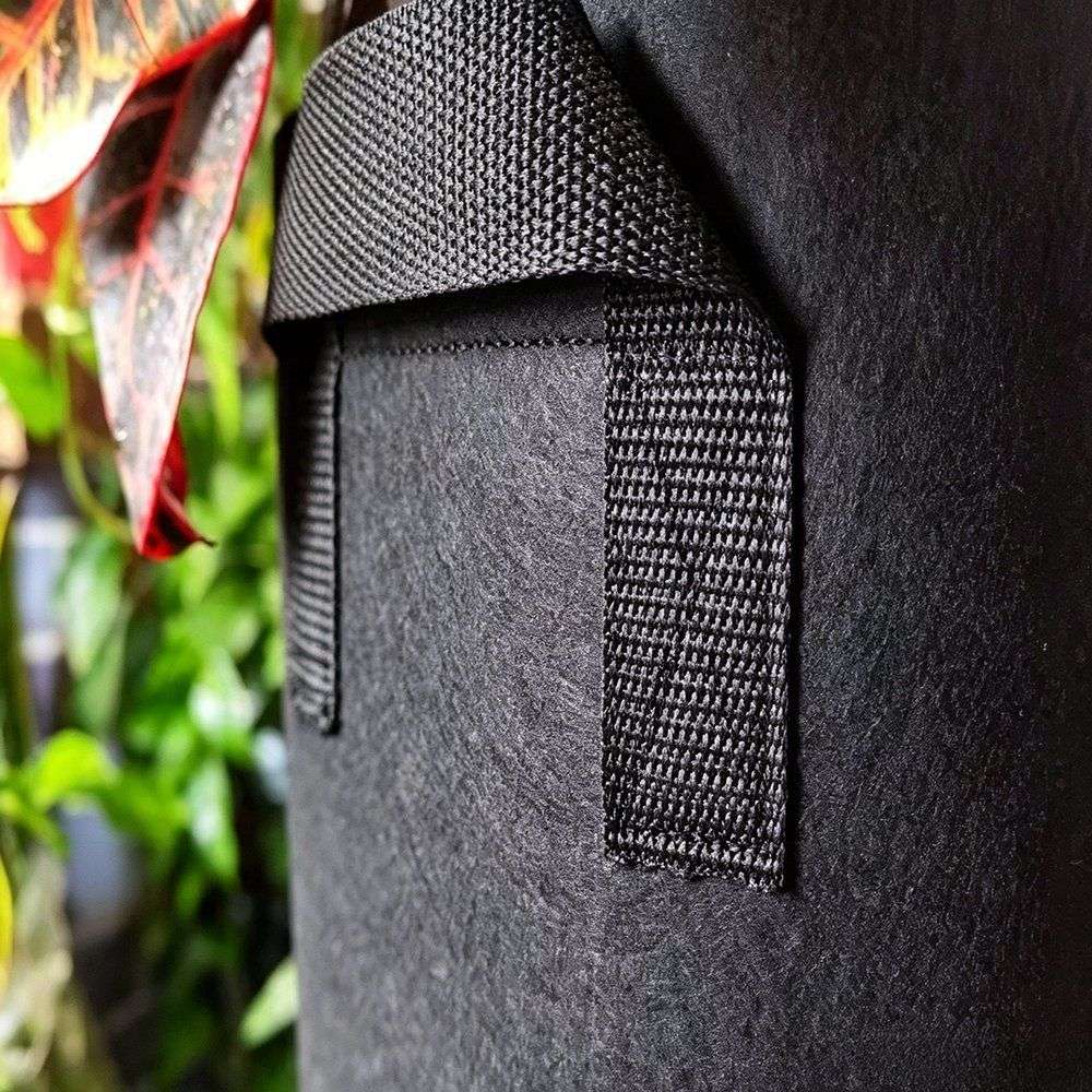 close up of the woven fabric and reinforced handle stitching on a grow bag