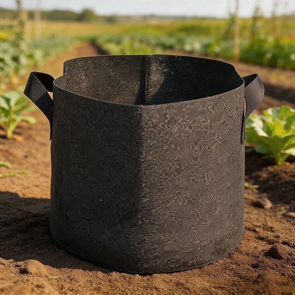 single fabric grow pot standing on cultivated ground with a seedling