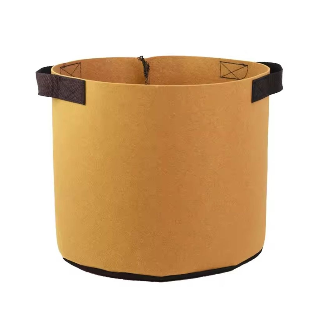 tan nonwoven grow bag with webbing handles on a white background